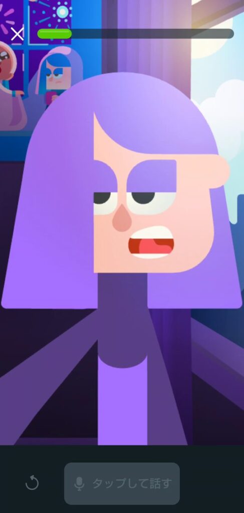 デュオリンゴのビデオ通話の画面。紫色の髪のキャラクター、リリーが口を大きく開けて話しかけている。画面の下には「タップして話す」のボタンがある